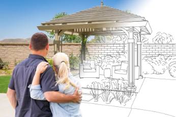 a couple happy to try out their pergola designed and built by Ipswich Carports